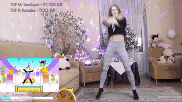 a woman is dancing in a living room in front of a screen that says ' top m ' on it