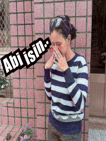 a woman in a blue and white striped sweater covering her face with her hands with the words abi isin above her