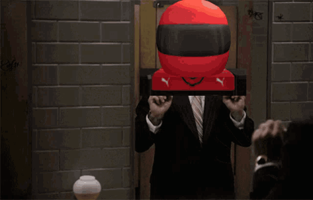 a man in a suit with a red helmet on his head says it 's showtime, folks