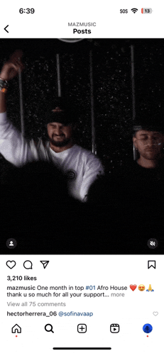 a phone screen shows a picture of two men and says mazmusic posts at the top