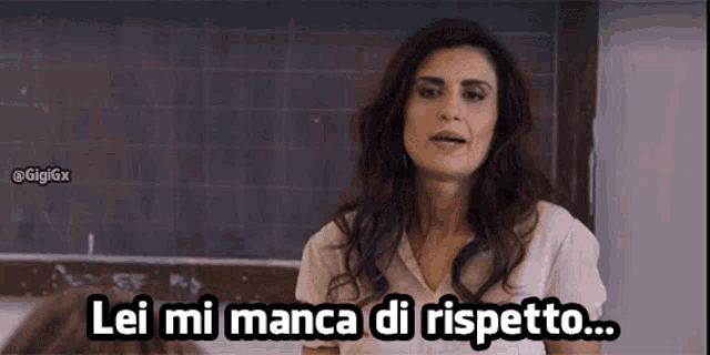 a woman stands in front of a blackboard and says lei mi manca di rispetto ..