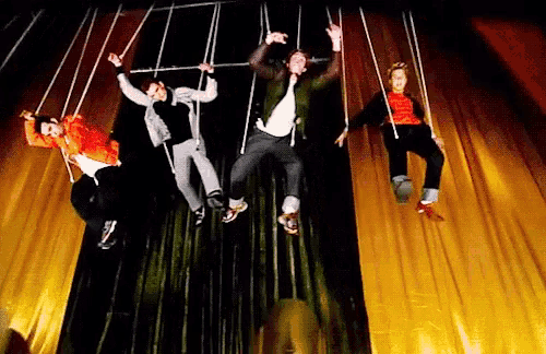 a group of people are hanging upside down on a rope
