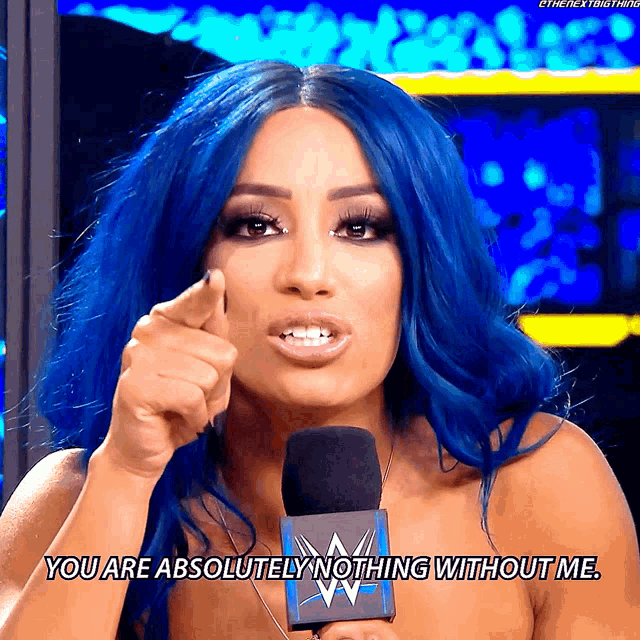 a woman with blue hair is talking into a microphone and says you are absolutely nothing without me