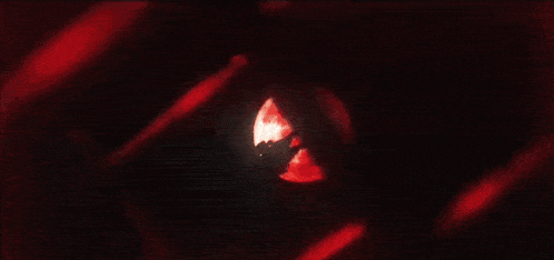 a close up of a red glowing object on a black background