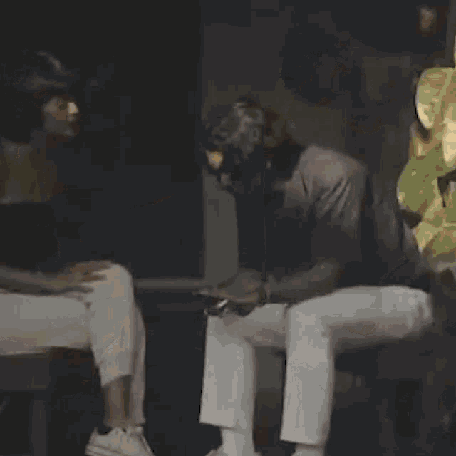 a man and a woman are sitting next to each other in a dark room .