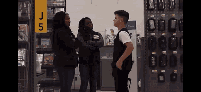 a group of people standing in front of a sign that says j5