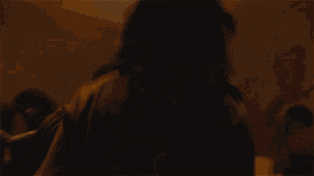 a crowd of people dancing in a dark room