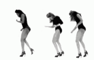 a black and white photo of three women dancing