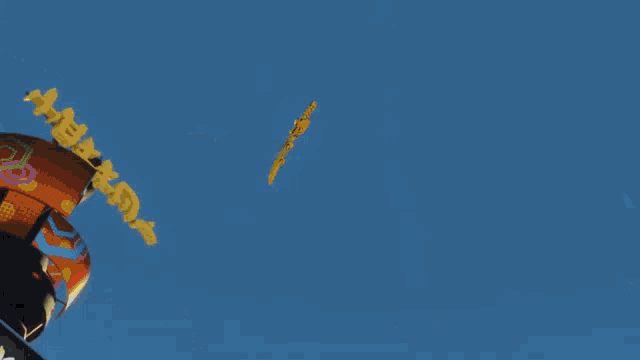 a blurred image of a city with a yellow object in the foreground that looks like a dragon 's tail