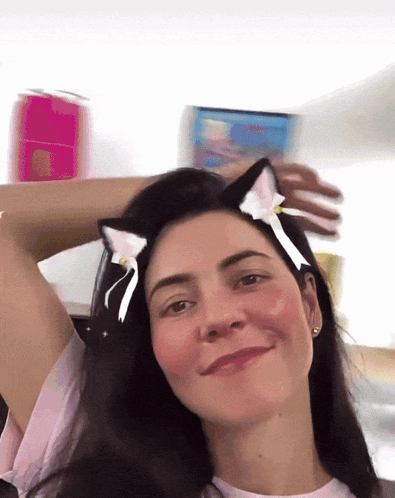 a woman wearing a pair of cat ears on her hair