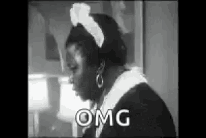 a black and white photo of a woman in a maid costume with the word omg written on it .