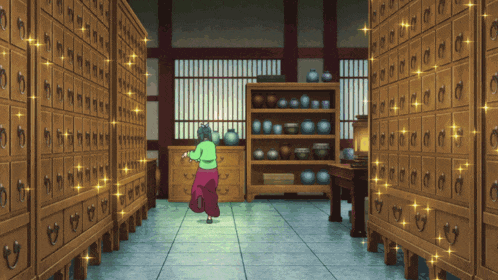 a woman in a green shirt is walking through a room with lots of drawers