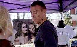 a man standing in front of a purple tent with a shirt that says make 3