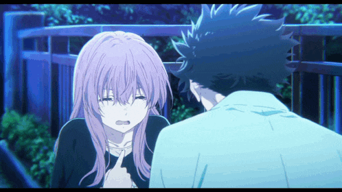 a boy and a girl are standing next to each other and the girl is crying