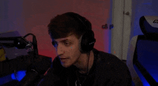 a man is sitting in front of a microphone in a room .