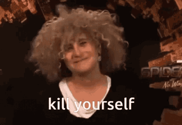 a woman with curly hair says kill yourself in front of a spider-man poster