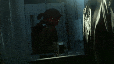a man with blood on his face is in a room with a box that says ' nc ' on it