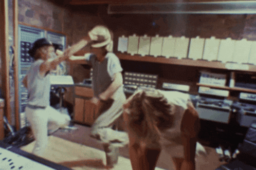 a man in a cowboy hat is standing next to a woman in a kitchen