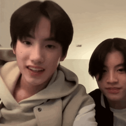 a boy and a girl are sitting next to each other and smiling for the camera