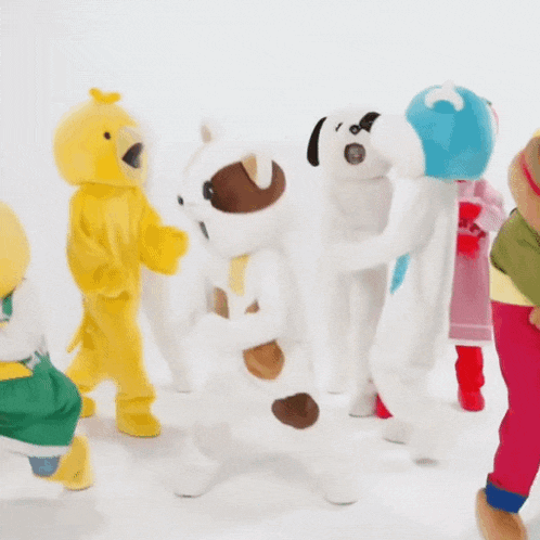 a group of stuffed animals with one wearing a shirt that says " mear "