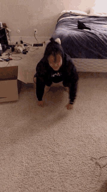 a person is doing push ups in a bedroom