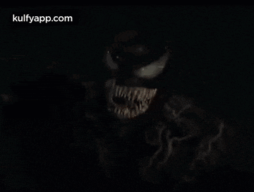 a close up of venom 's mouth in the dark with the website kulfyapp.com visible in the corner