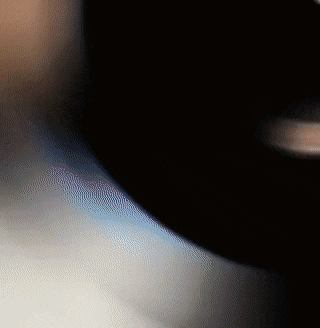 a blurry image of a person 's face with a black background