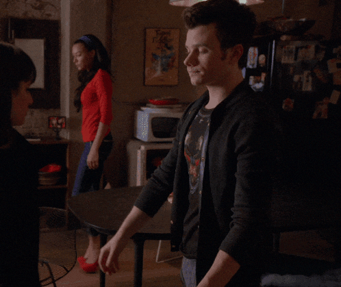 a man and a woman are looking at each other