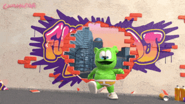 a gummy bear is running through a hole in a brick wall with graffiti on it