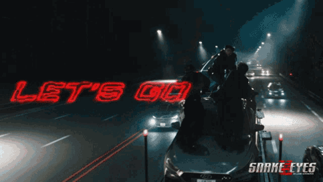 a neon sign that says let 's go is lit up on a highway