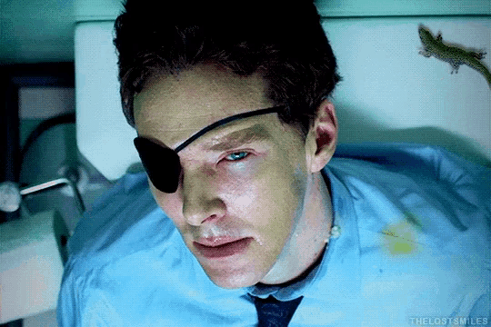 a man with a patch on his eye is laying in a hospital bed with the words the lost smiles below him