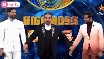 three men in suits are standing next to each other on a stage .