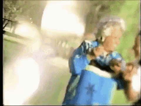a blurry picture of a person holding a blue bag