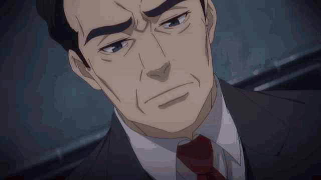 a man in a suit and tie is looking down