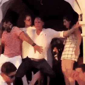 a man in a white polo shirt is being lifted by a woman