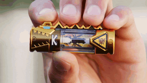a person is holding a toy with a k on it