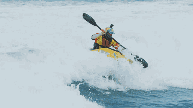 a person in a yellow kayak with a paddle that says jet ski