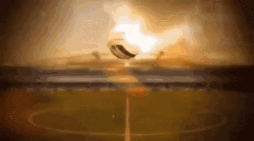 a soccer ball is flying through the air in front of a stadium
