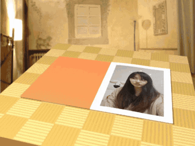 a picture of a woman is on a table with a checkered tablecloth