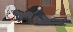 a girl is laying on the floor playing with a cat