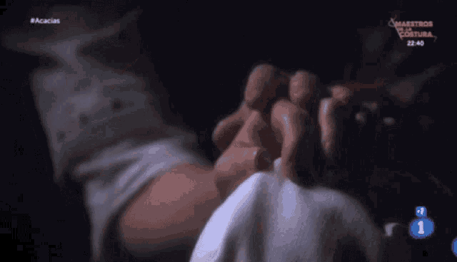 a close up of a person holding another person 's hand with the number 1 on the screen