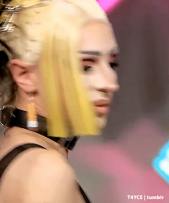 a close up of a woman 's face with yellow hair