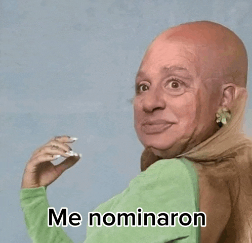 a woman with a shaved head is wearing a green shirt that says me nominaron