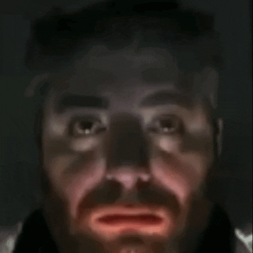 a close up of a man 's face with red lips