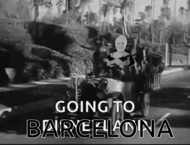 a black and white photo of a woman driving a car with the words `` going to barcelona '' on the bottom .