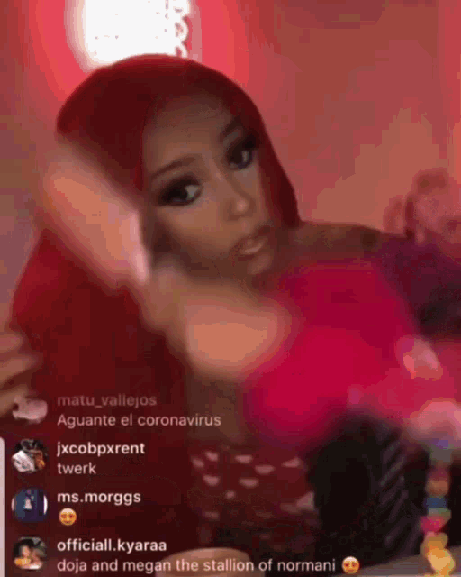 a woman with red hair and a pink shirt is being viewed by a group of people