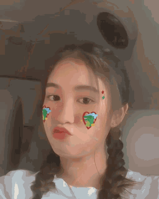a girl with a heart on her face makes a face
