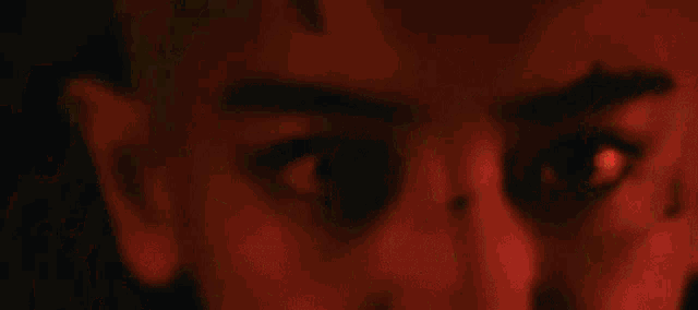 a close up of a person 's face in flames