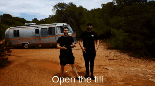 two men standing in front of an airstream that says open the till on the bottom