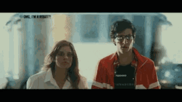 a man and a woman are standing next to each other and the man is wearing a red jacket